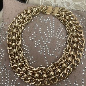 Costume jewelry it’s a gold 18 inch choker 1 1/2 inches wide stunning piece
